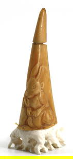 Chinese Carved Hornbill Snuff Bottle: Chinese Carved Hornbill Snuff Bottle The natural horn body severed to form the cap, carved with a seated rabbit before a carrot, on a differing material base, with scoop. Height 3.5 in. Snuff