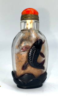 Chinese Overlaid Peking Glass Snuff Bottle: Chinese Overlaid Peking Glass Snuff Bottle The footed two-toned ovoid body carved with a fish leaping out of water on each side, brown overlaid on colorless glass, with a coral domed cap and with