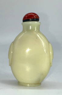 Chinese Opaline Peking Glass Snuff Bottle: Chinese Opaline Peking Glass Snuff Bottle The footed ovoid green tined white glass bottle with faux mask handles at each side, with a russet domed cap, with scoop. Height 3 in. Snuff bottles were
