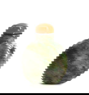 Chinese Mottled Green Marble Snuff Bottle: Chinese Mottled Green Marble Snuff Bottle The circular body with light to dark green inclusions and mottling, the domed russet agate cap with a scoop. Height 3.25 in. Snuff bottles were personal