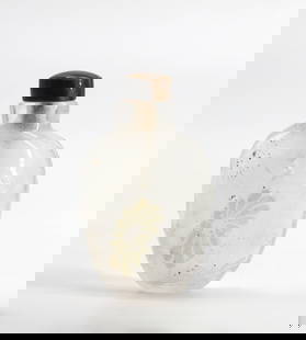 Chinese Rock Crystal Snuff Bottle: Chinese Rock Crystal Snuff Bottle The ovoid body delicately carved with a blossoming flower amidst clouds, with a tigers eye cap, with scoop. Height 3 in. Snuff bottles were personal objects of