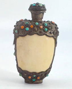 Tibetan Jeweled and silvered Metal Snuff Bottle: Tibetan Jeweled and silvered Metal Snuff Bottle The ovoid body mounted with a framework mounted with turquoise and coral beads,The domed cap with a metal scoop. Height 3.5 in. Snuff bottles