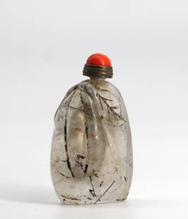Chinese Carved Rock Crystal Snuff Bottle: Chinese Carved Rock Crystal Snuff Bottle The asymmetrical body with internal fractures and carved in high relief with a blossoming pumpkin, the metal coral cap with scoop. 2.25 in. Snuff bottles