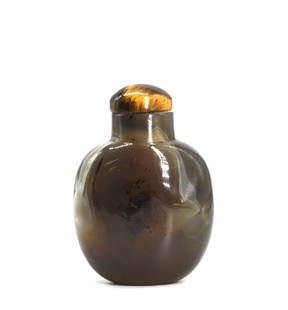 Good Chinese Chalcedony Snuff Bottle: Good Chinese Chalcedony Snuff Bottle The circular slate gray agate with whisps of white, the tigers eye cap with scoop. Height 3.25 in. Snuff bottles were personal objects of luxury and