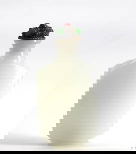 Chinese Faux Jade Glass Snuff Bottle: Chinese Faux Jade Glass Snuff Bottle The footed rectangular celadon tinted opaque glass body with a shaped neckand cabochon mounted metal cap, with scoop. Height 3.25 in. Snuff bottles were