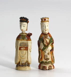 Pair of Chinese Polychromed Carved Male and Female Snuff Bottles: Pair of Chinese Polychromed Carved Male and Female Snuff Bottles Each an elaborately dressed noble, the caps carved as heads, both with scoops.Height 3 in. Snuff bottles were personal objects of