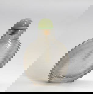 Good Carved Rock Crystal Snuff Bottle: Good Carved Rock Crystal Snuff Bottle The circular footed body carved on one side with a landscape in low relief, with wide neck with a celadon quartz cap with a scoop. 3.5 in. Snuff bottles were