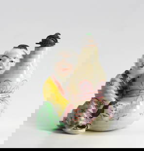 Chinese Painted Porcelain Snuff Bottle: Chinese Painted Porcelain Snuff Bottle Modelled as a boy besides a ribbon-tied double gourd, the domed metal cap with a green mineral cabochon. Height 2 in. Snuff bottles were personal objects