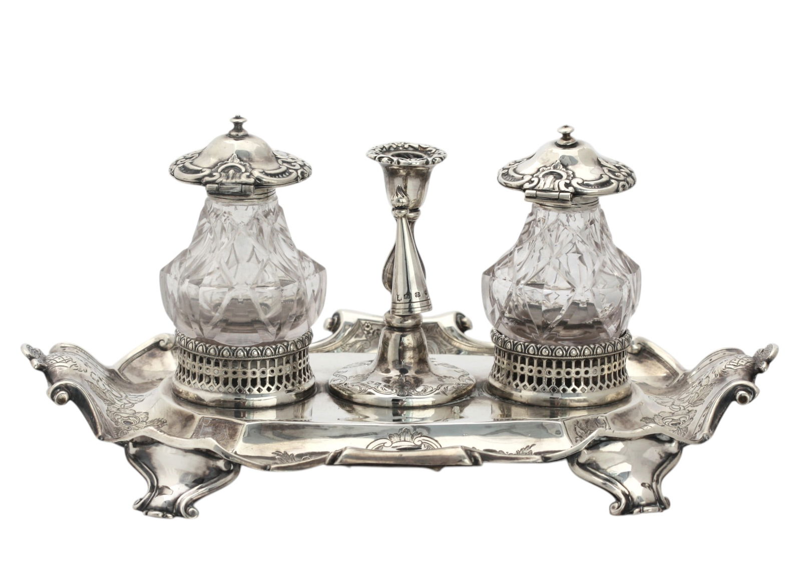 Victorian Silver and Cut-Glass Ink Standish: Sheffield, circa 1854 Silver and Cut-Glass Ink Standish,A finely crafted mid-19th century ink stand of elegant design. The shaped rectangular base is richly engraved with scrolling foliage and