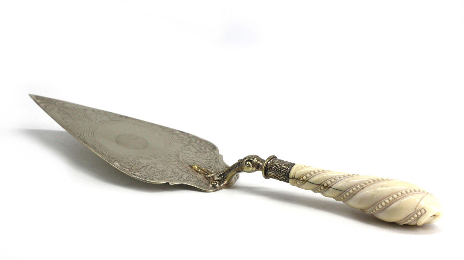 Good Victorian Silver Plate Cake Slice: Good Victorian Silver Plate Cake Slice Mid to late 19th century. The foliate scroll and figural engraved trowel with a bead and spiral twist handle. Length 14 in.