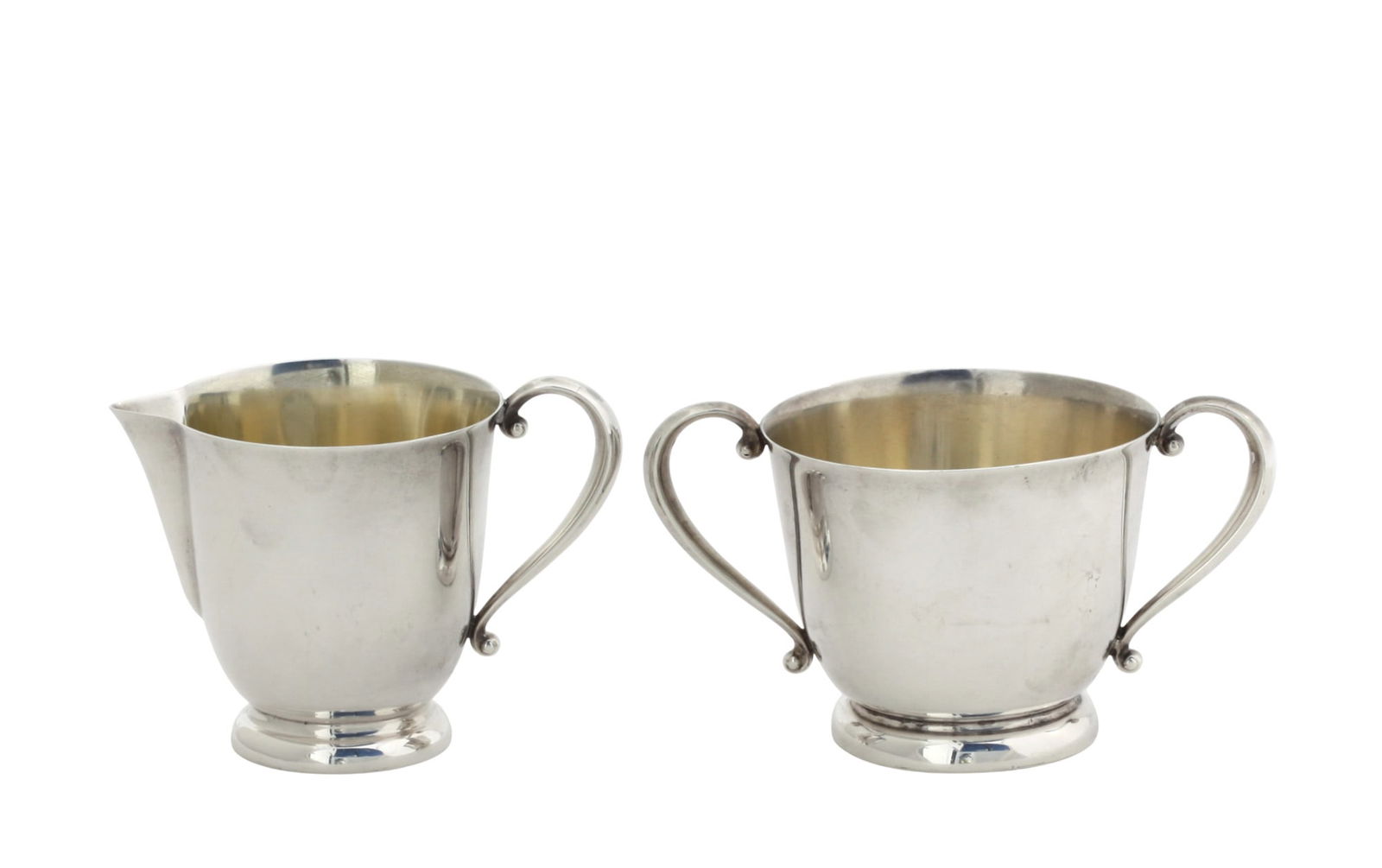 International Silver Creamer and Sugar Bowl: International Silver Creamer and Sugar Bowl Each marked, numbered C148. Of tapering circular form on a raised circular foot, with scrolled handles. Height of creamer 3.25 in. 8.6 troy ozs.