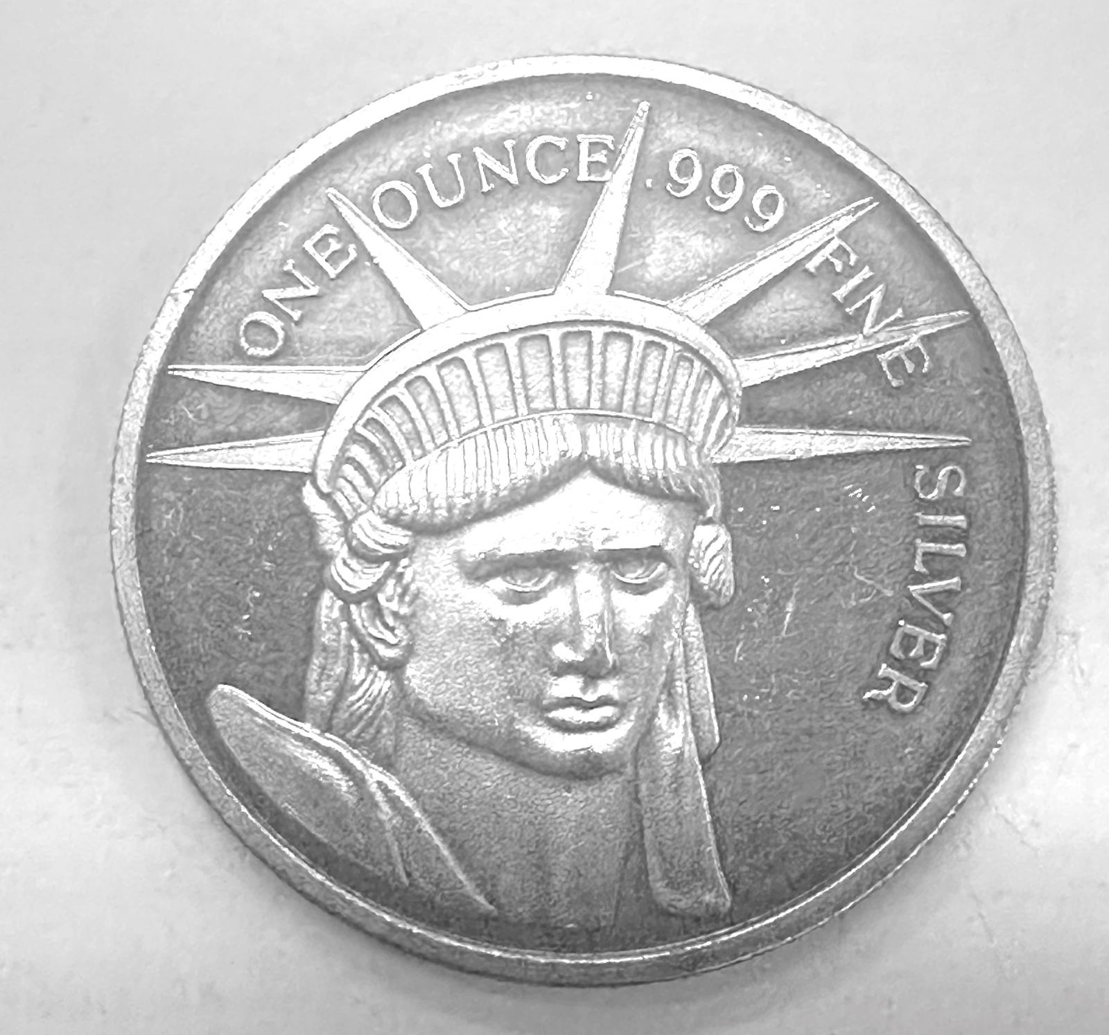 1 oz. Silver Coin, Statue of Liberty Head: 1 oz. Silver Coin, Statue of Liberty Head .999 fine silver, the reverse with displayed eagle, inscribed, Give me your tired and poor, ..... Statue of Liberty verse.
