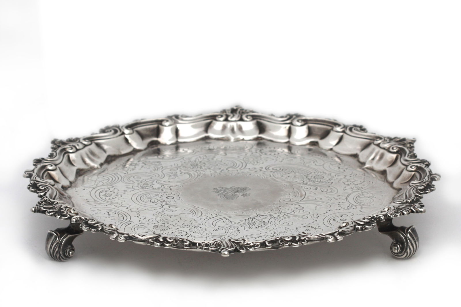 Rococo Style Silver Footed Salver: Rococo Style Silver Footed Salver English or Continental. 19th Century. Appears unmarked. The shaped circular tray with a stylized asymmetrical wave or leaf border, the recess incised, with foliage an