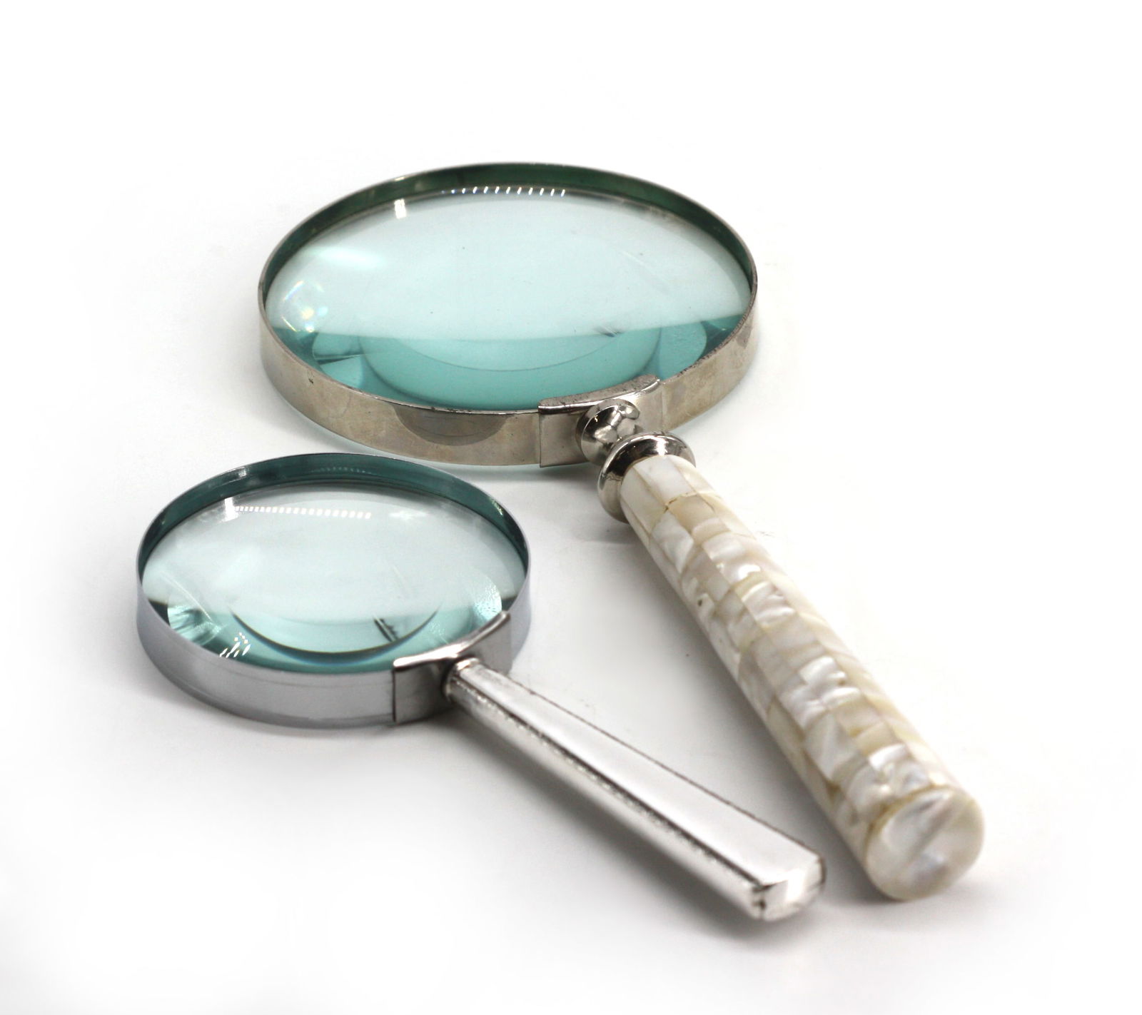 Two Magnifying Glasses: Two Magnifying Glasses One with a sterling silver handle, the other with a pieced mother-of-pearl handle. Length 6.75 in., 10 in., respectively.