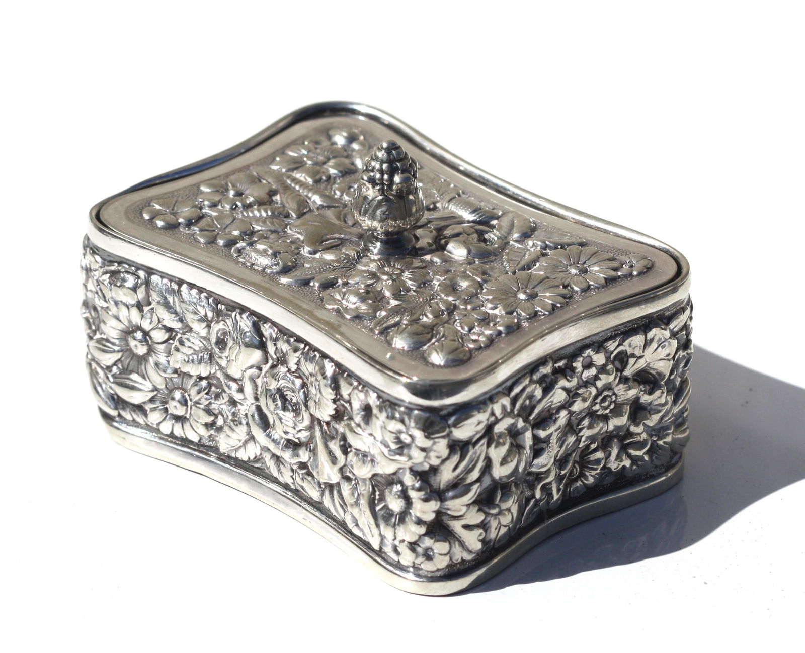 Tiffany & Co. Silver-Soldered Stamp Box and Cover.: Tiffany & Co. Silver-Soldered Stamp Box and Cover. Early 20th. Century. Of slightly curved rectangular form, cast with allover foliage. 3 by 2.25 in.