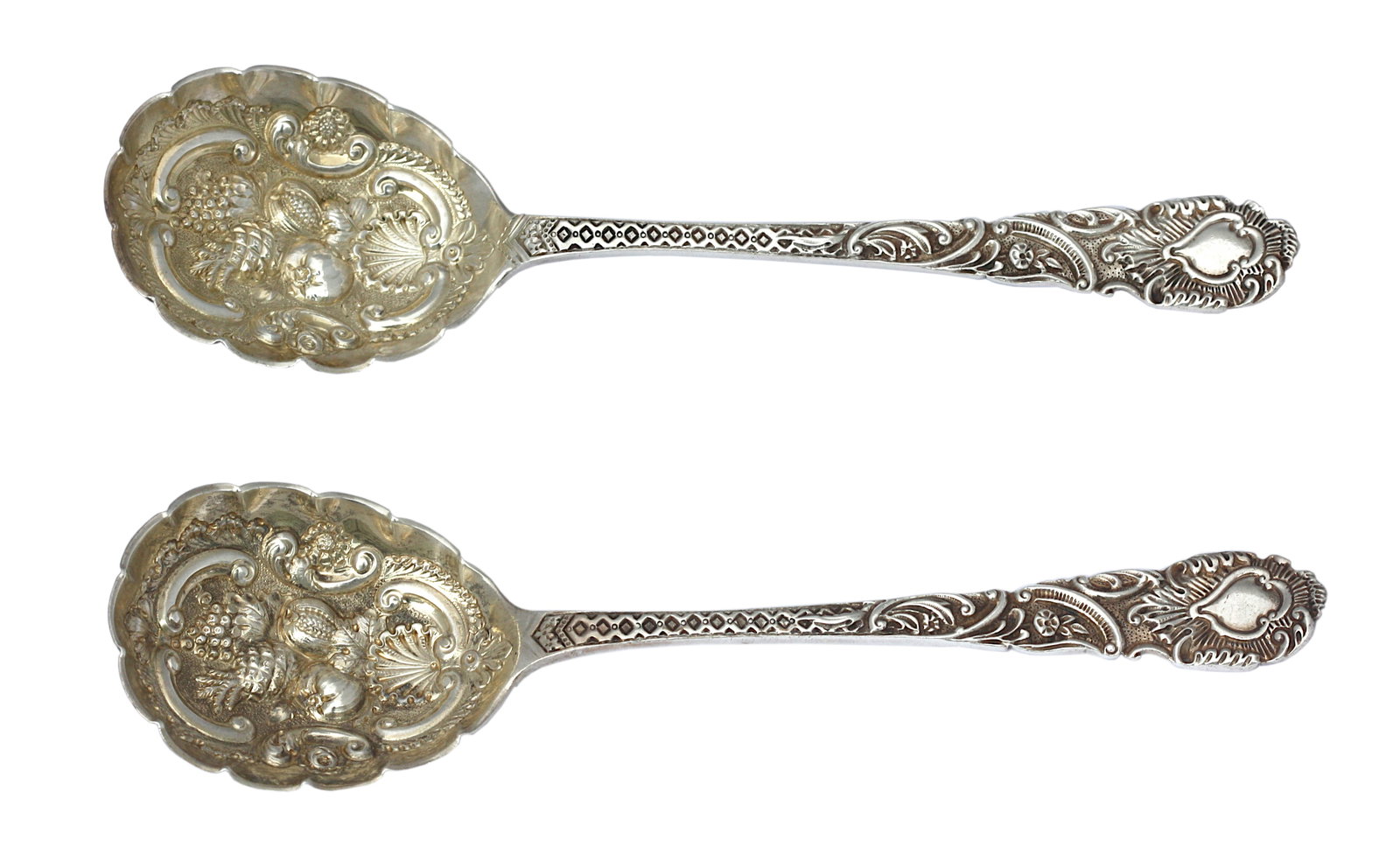Pair of Victorian Silver Berry Spoons: Pair of Victorian Silver Berry Spoons English, 1865. In a rococo style, the scoops with repose scrolls, a shell, and fruit. 6.5 troy oz. Length. 9.75 in.