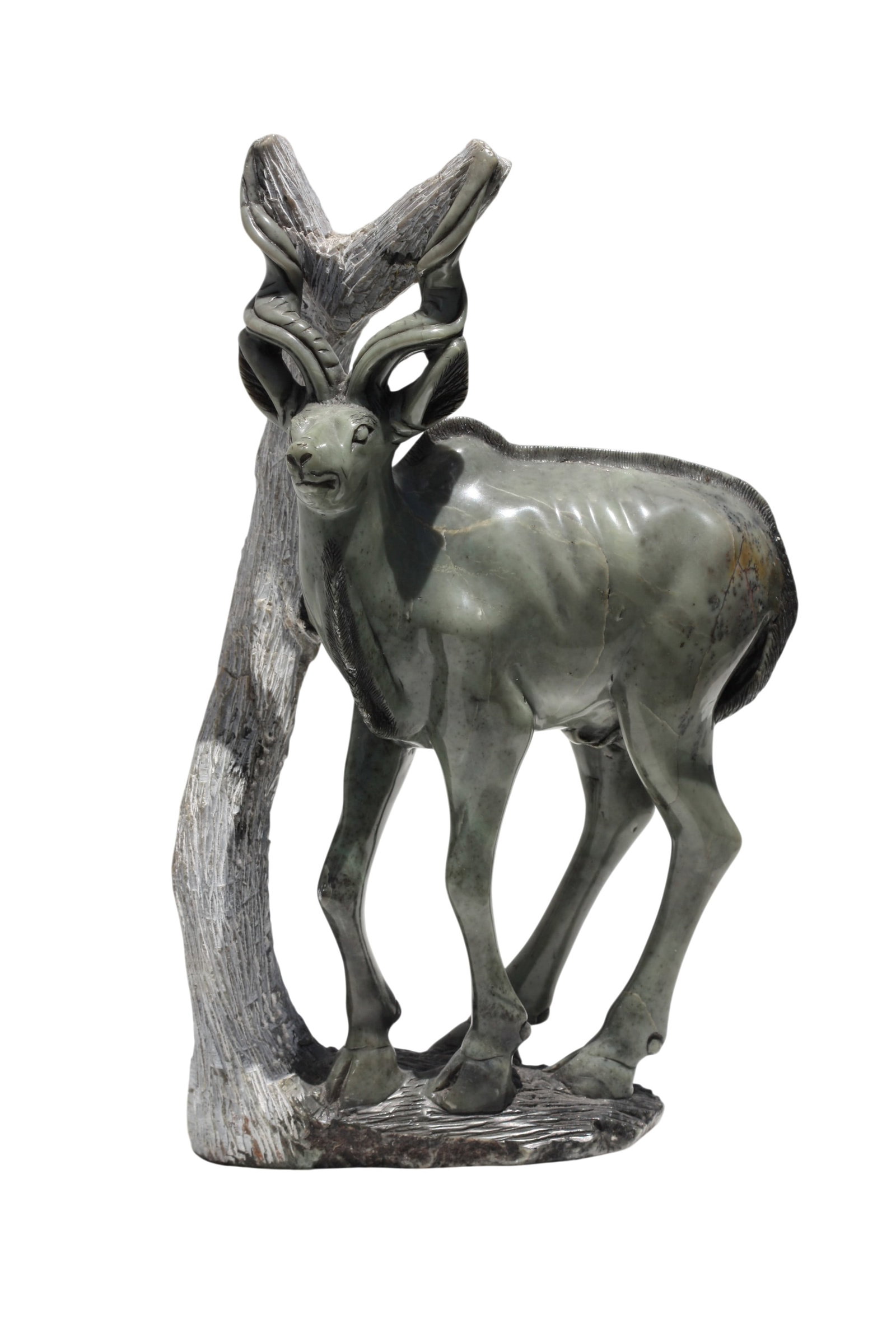 Contemporary African Carved Stone Male Kudu: Contemporary African Carved Stone Male Kudu The grayish-green stone carved as a Kudu before a tree on a grassy mound. Height 16.5 in., Width 11 in., Depth 6.5 in.