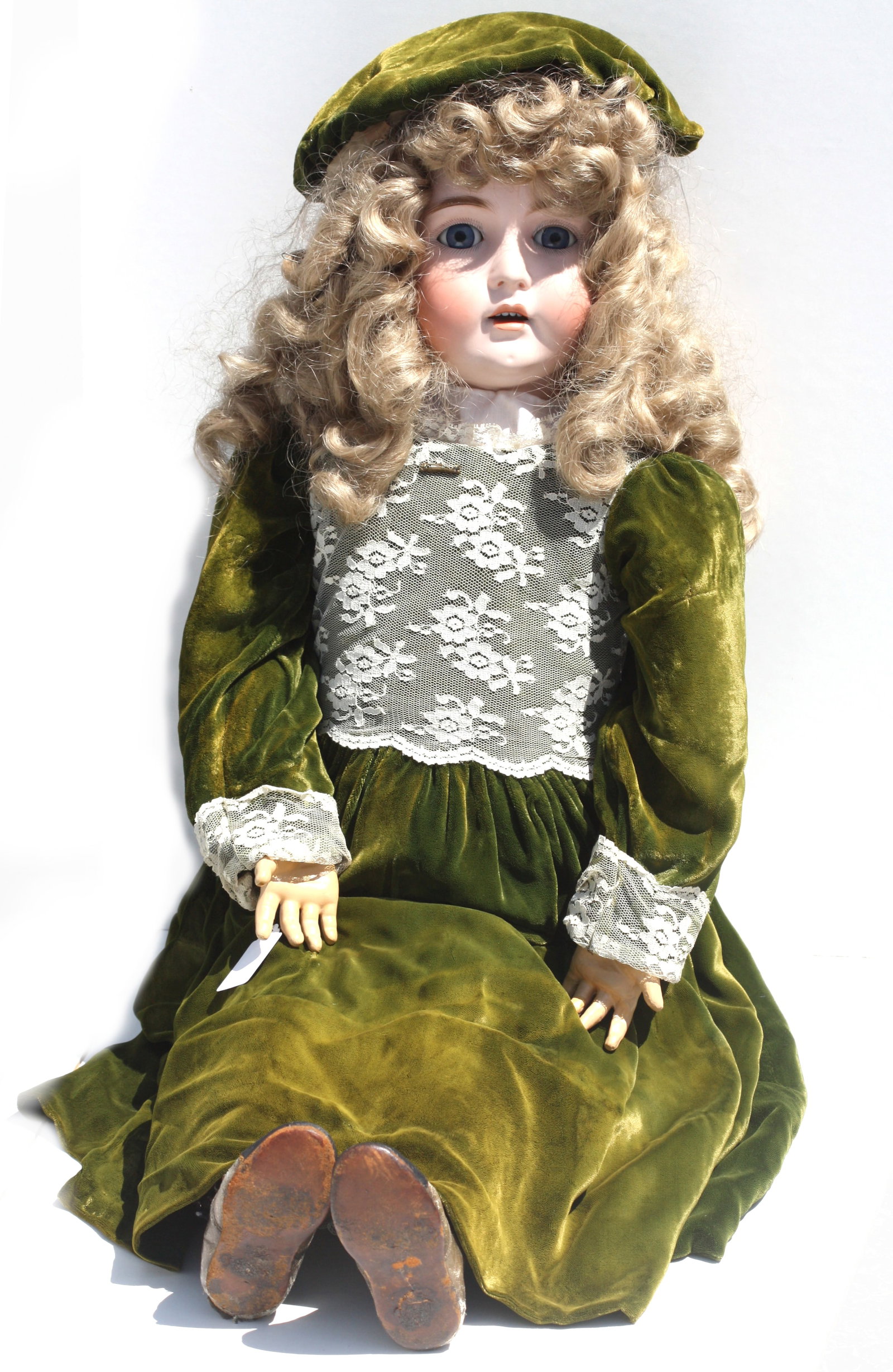 Large European Bisque Head Doll, probably German: Large European Bisque Head Doll, probably German The neck with a red stamp, circa 1900. This charming antique bisque head doll features striking blue glass sleep eyes, delicately painted lashes, feath
