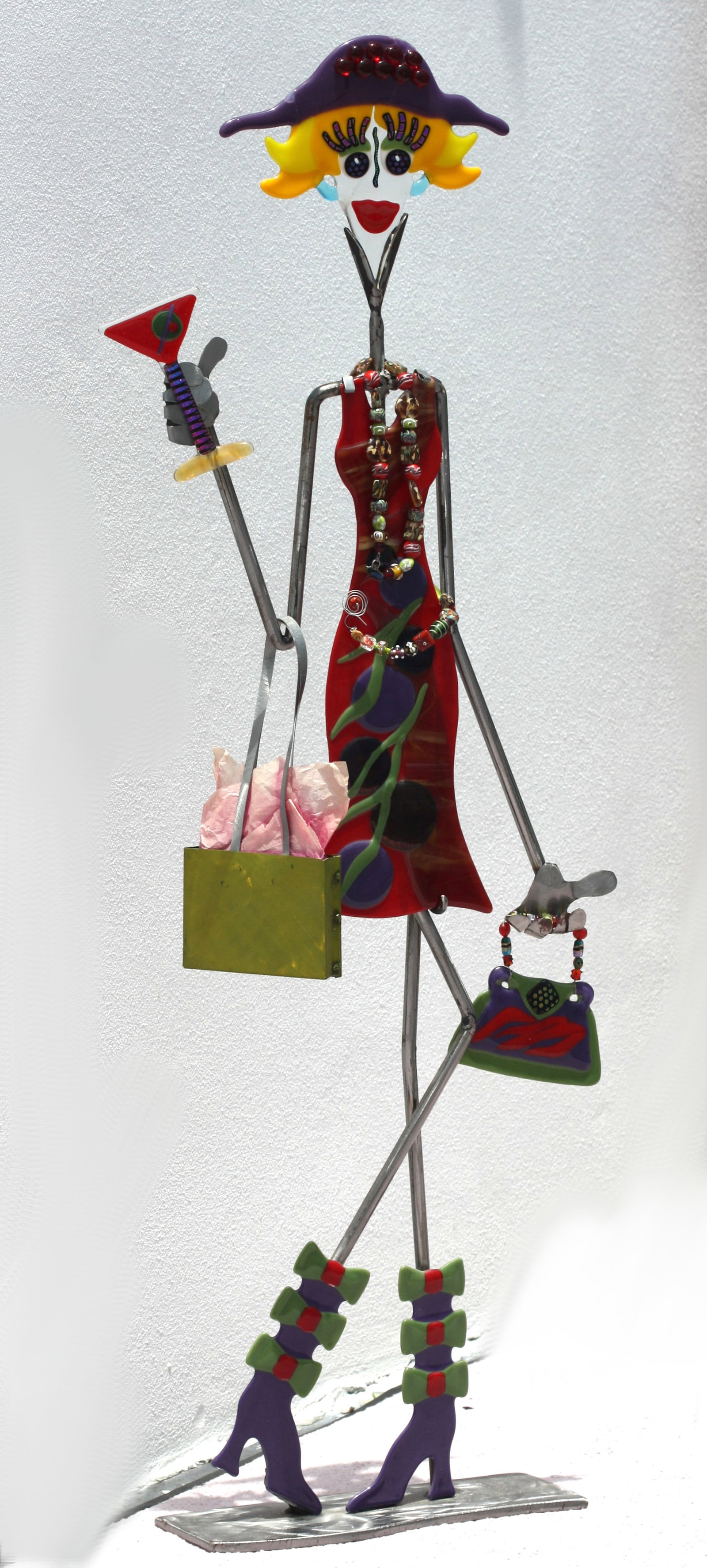 Contemporary Glass Figure of a Female Millennial: Contemporary Glass Figure of a Female Millennial Unsigned, depicting a young party girl shopping. Height 51 in., Width 17 in., Depth of base, 5.5 in.