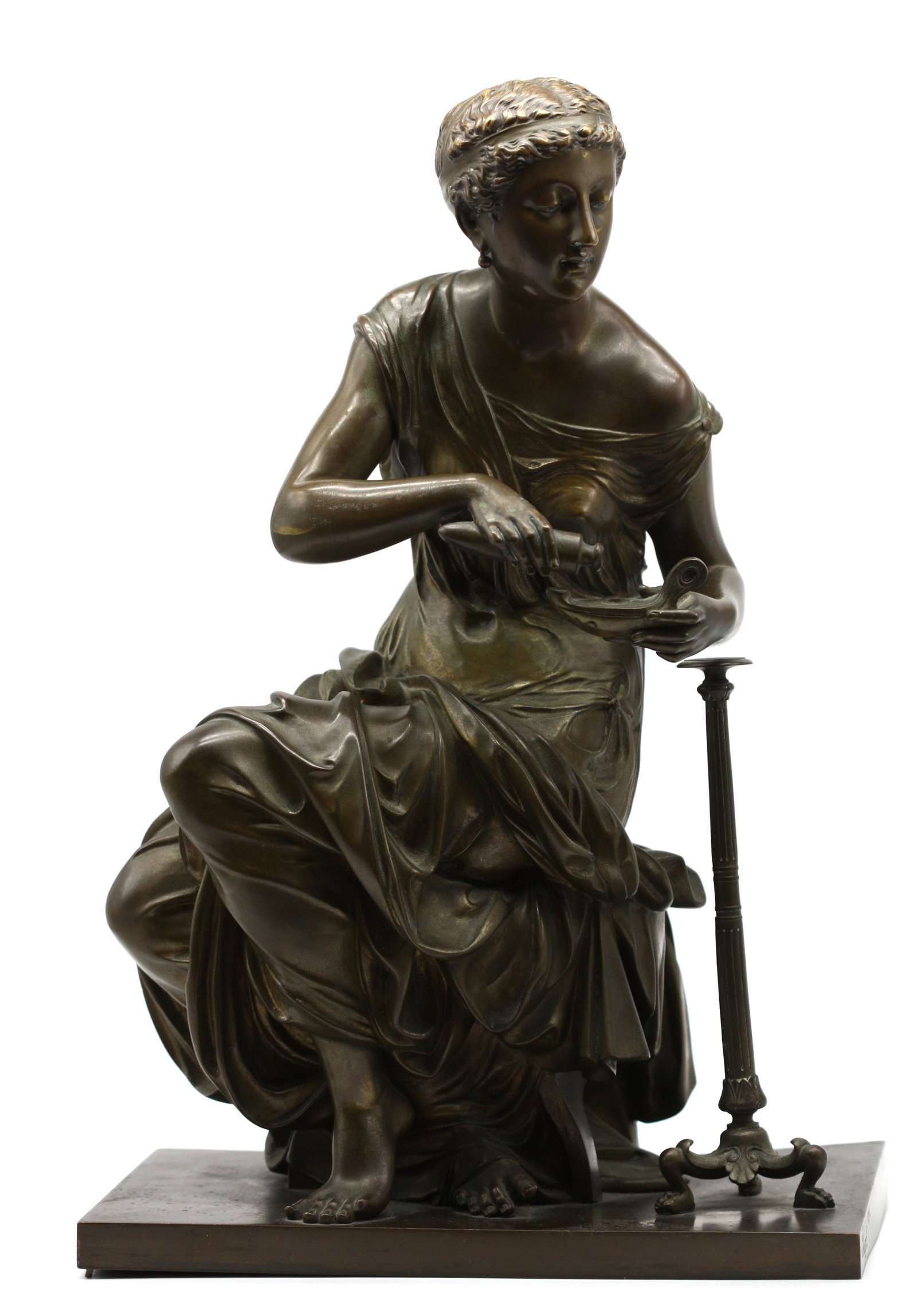 Continental Patinated Bronze of a Classical Maiden: Continental Patinated Bronze of a Classical Maiden Late 19th/early 20th Century. Italian or French. The seated young maiden in classical attire, lighting a lamp before a torchere, on a rectangular bas