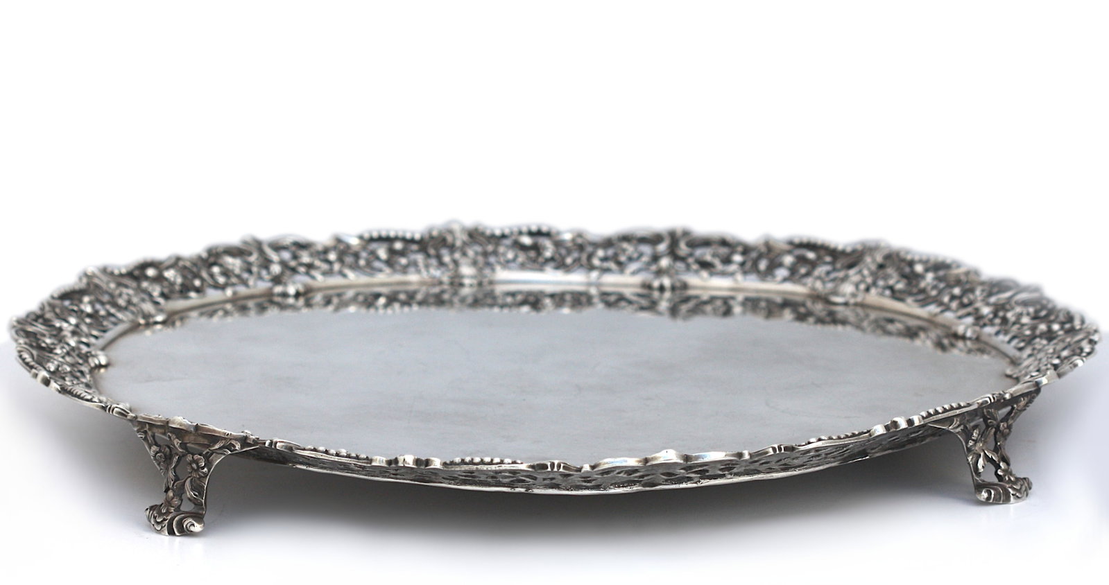 George III Silver Footed Serving Tray: George III Silver Footed Serving Tray Marked London, circa 1760, by Richard Rugg Of circular form, the tray with an applied border cast in openwork foliage and interlaced scrolls, accented by delicate