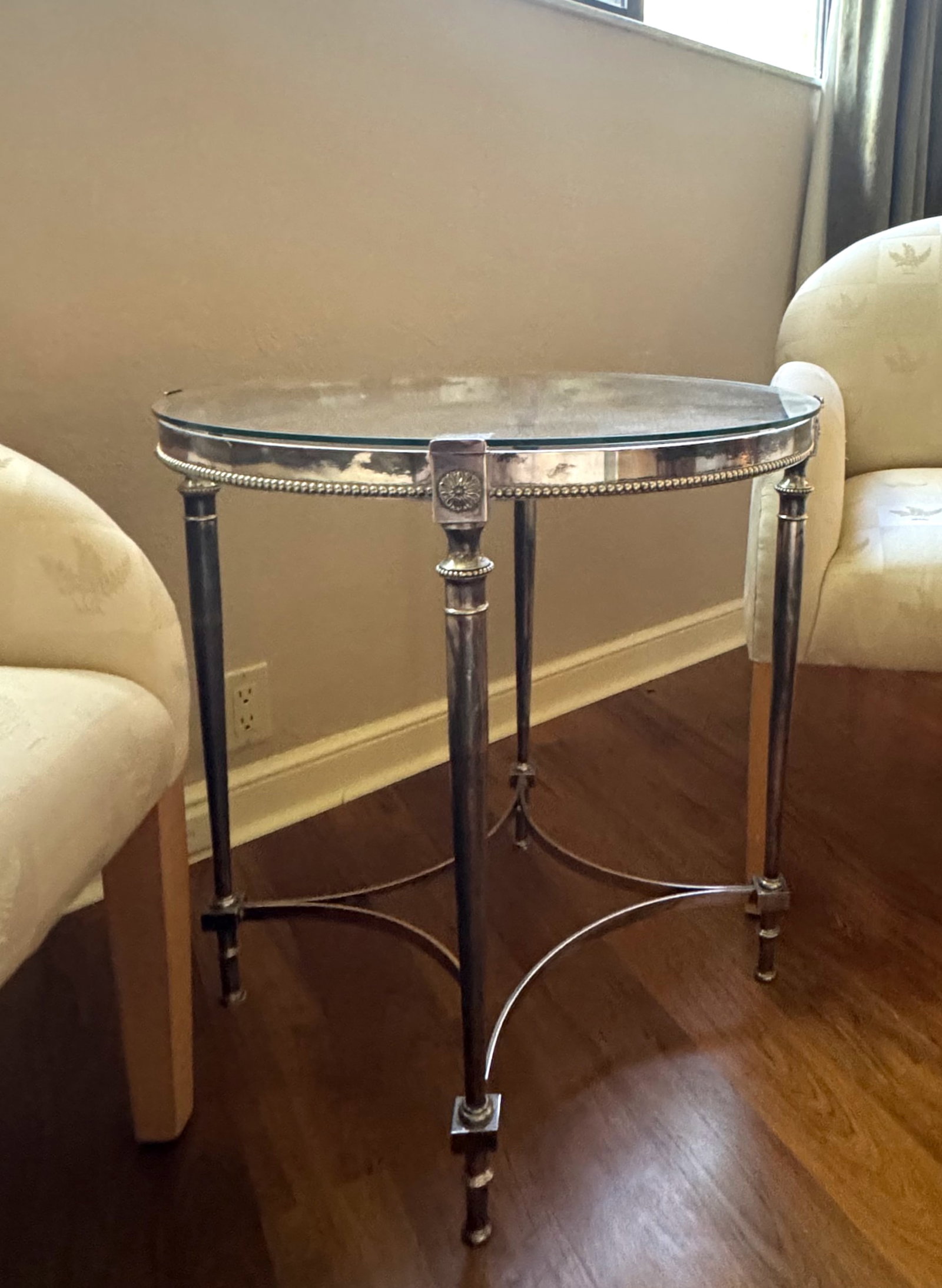 Contemporary Louis XVI Style Polished Steel Ocassional Table: Contemporary Louis XVI Style Polished Steel Ocassional Table Circular, with a glass top, above a beaded frieze, on tapering columnar legs, joined by four concave stretchers, ending in tapering toupie