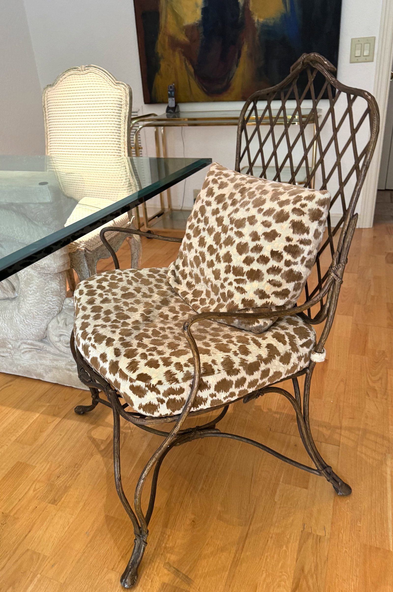 Set of Four Patinated Metal Patio Armchairs: Set of Four Patinated Metal Patio Armchairs the frames cast as branches, with arched trellis backs and shaped seats, the seats and backs with loose cushions. Height of backs, 40 in., Width 24.5 in., D
