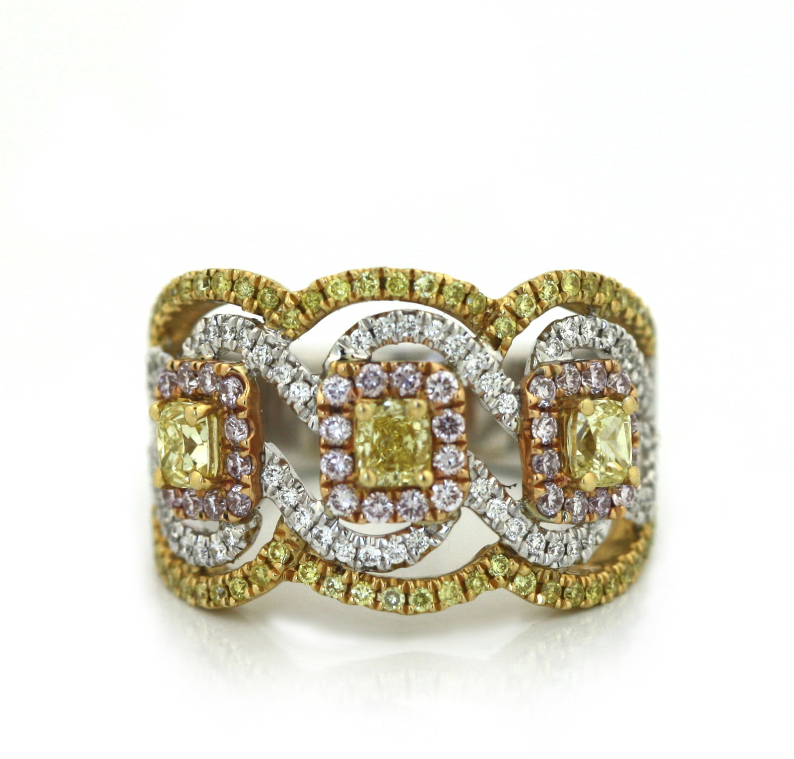 18K White and Yellow Gold Fancy Yellow, Pink and White Diamond Ring: 18K White and Yellow Gold Fancy Yellow, Pink and White Diamond Ring. Designed in an elaborate openwork crossover motif, the ring is set with three fancy yellow radiant-cut diamonds weighing approximat