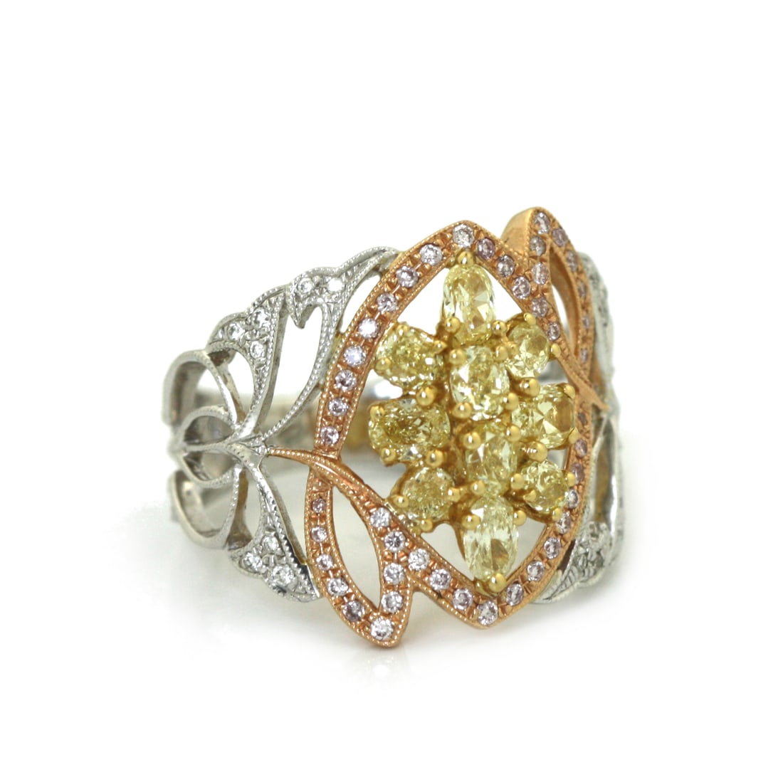 18K White and Rose Gold Fancy Yellow, Pink and White Diamond Ring.: 18K White and Rose Gold Fancy Yellow, Pink and White Diamond Ring. Designed in an elaborate openwork floral motif, the ring is set with ten fancy yellow oval-cut diamonds weighing approximately 1.24 c