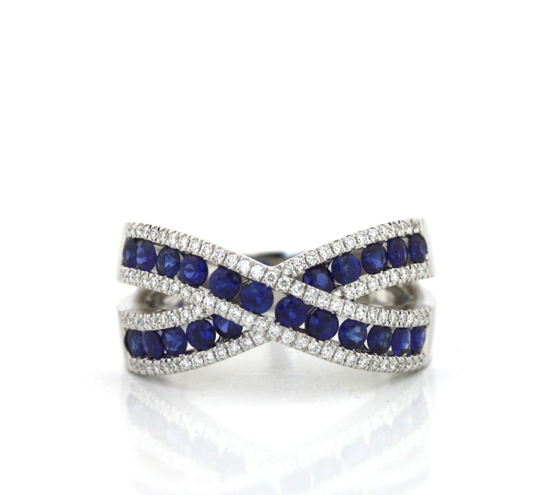 Sapphire and Diamond Crossover Ring: Sapphire and Diamond Crossover Ring in 14K White Gold. Designed in a contemporary crossover motif, the ring is set with twenty-two oval-cut sapphires weighing approximately 1.95 carats total, accented