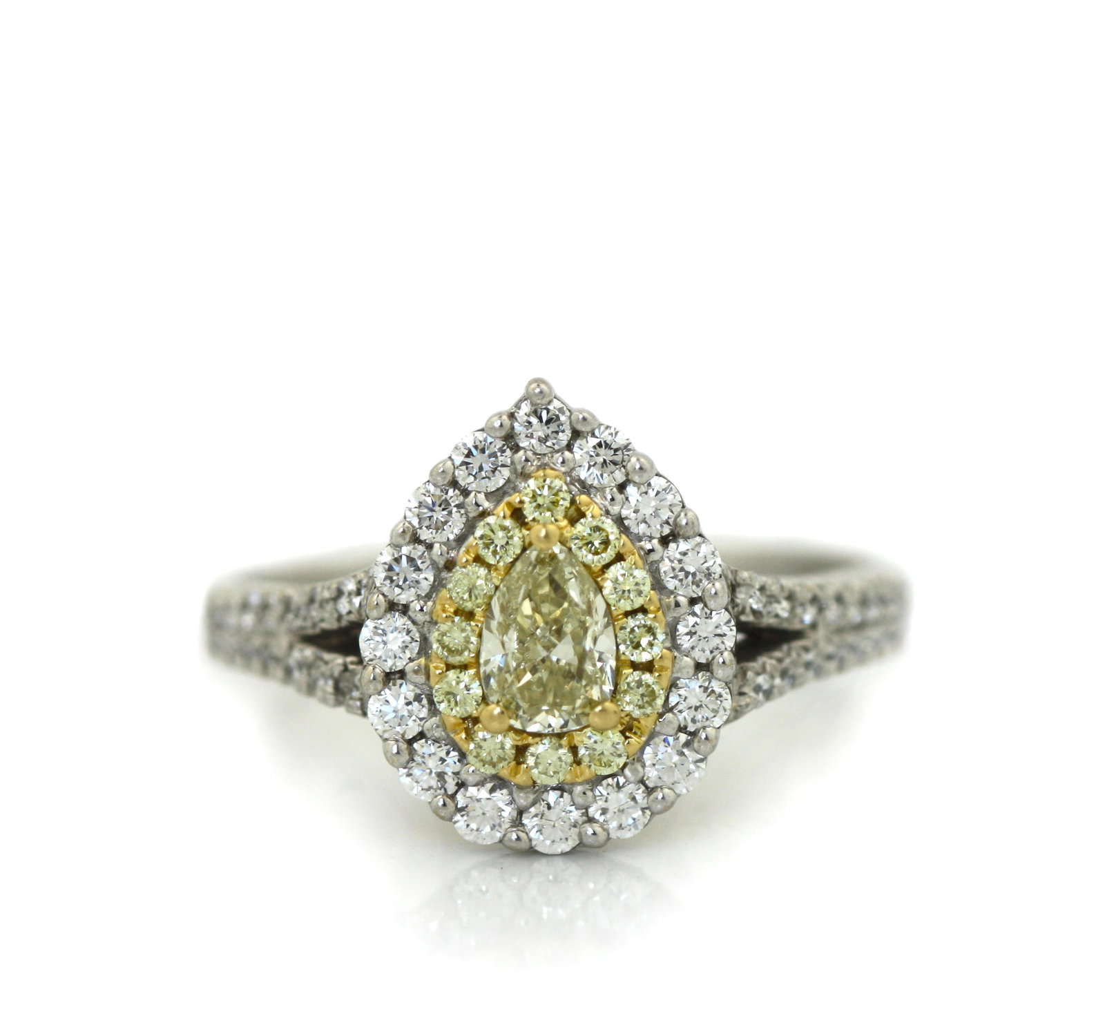 18K White Gold Fancy Yellow and White Diamond Ring.: 18K White Gold Fancy Yellow and White Diamond Ring. Centering one pear-shaped fancy yellow diamond weighing approximately 0.50 carats, surrounded by twenty-two fancy yellow round diamonds weighing app