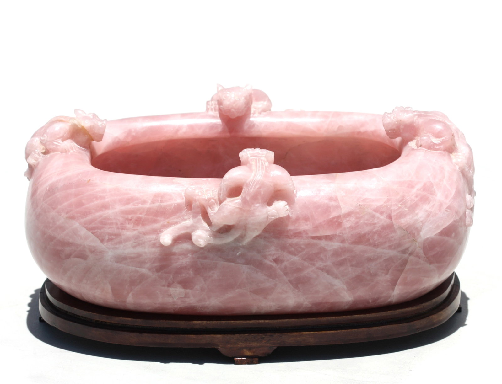 Chinese Carved Rose Quartz Bowl: Chinese Carved Rose Quartz Bowl The oval bowl with an in-turned rim supporting four mythical best on a wooden stand Hight 5 1/2 in. width 12 1/4 in. Depth 8 in.