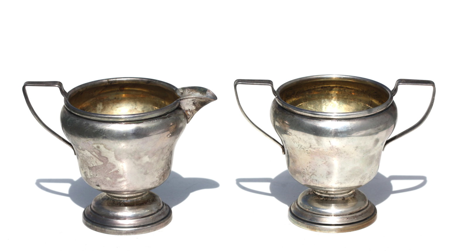American Sterling Silver Sugar Bowl and Creamer: American Sterling Silver Sugar Bowl and Creamer Marked Sterling, and J.W. with a displayed eagle. Both circular, with a gilt wash interior and angled handles. 8.2 troy ozs. Height of sugar bowl, 3.5 i