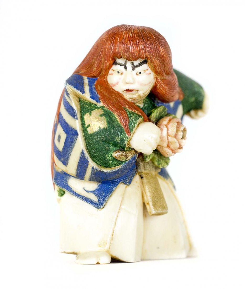 CARVED AND POLYCHROME IVORY NETSUKE: PROPERTY FROM A FLORIDA COLLECTION CARVED AND POLYCHROME IVORY NETSUKE Signed. Of a Kabuki dancer, in costume standing. Height 2 1/4 inches.
