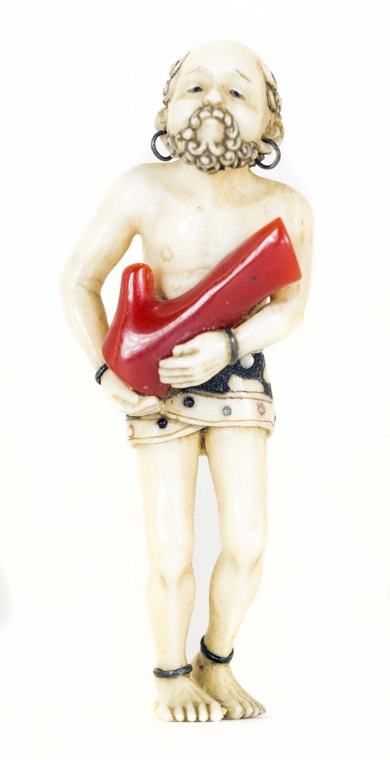 CARVED IVORY, AND CORAL NETSUKE: PROPERTY FROM A FLORIDA COLLECTION CARVED IVORY, AND CORAL NETSUKE Of a South Sea coral diver. Height 2 inches.