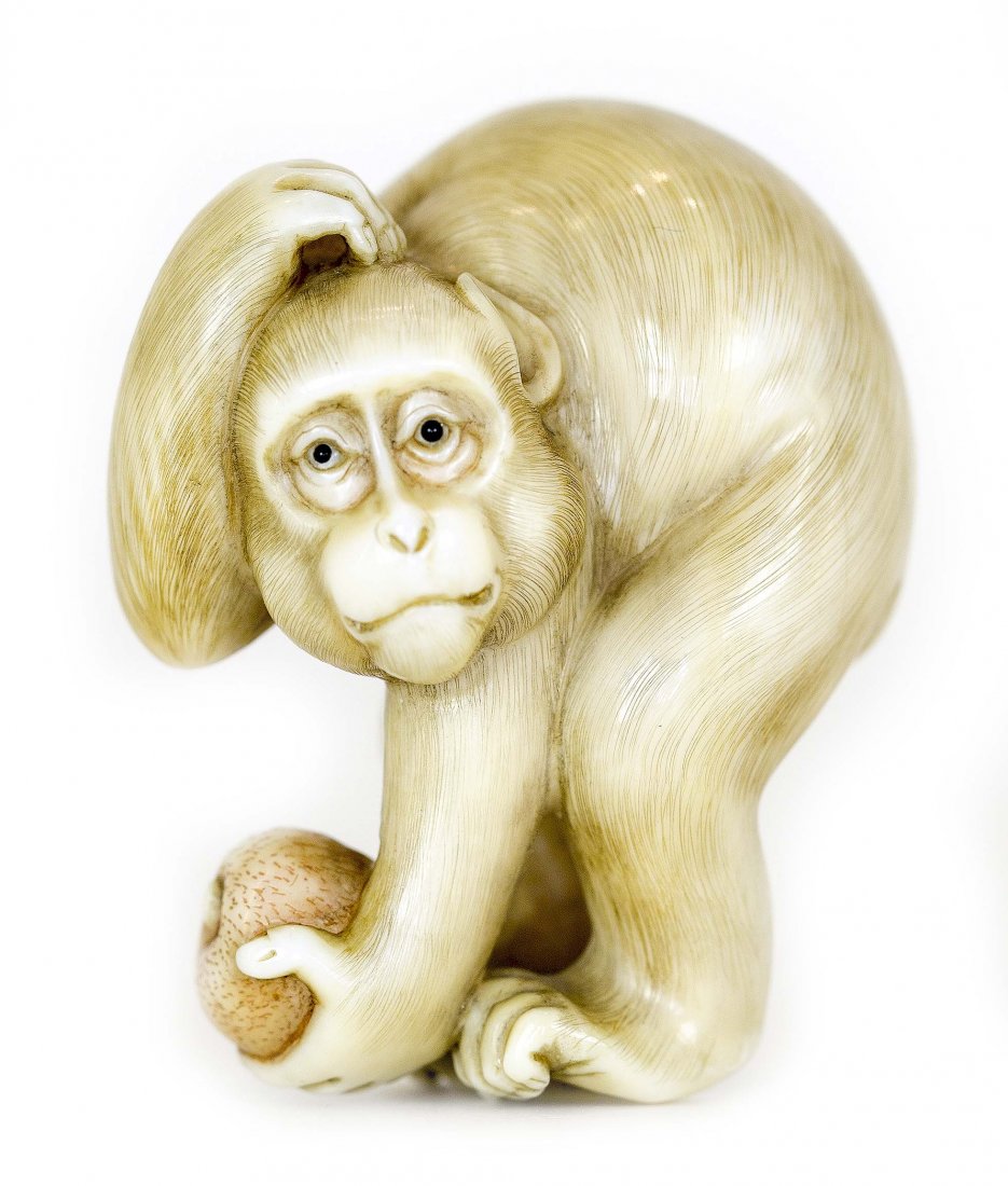 JAPANESE CONTEMPORARY IVORY NETSUKE BY KANGYOKU: PROPERTY FROM A FLORIDA COLLECTION JAPANESE CARVED AND INLAID IVORY NETSUKE Contemporary. Signed Kangyoku. Of a monkey, scratching its head and holding a biwa fruit. Height 1 3/4 inches.