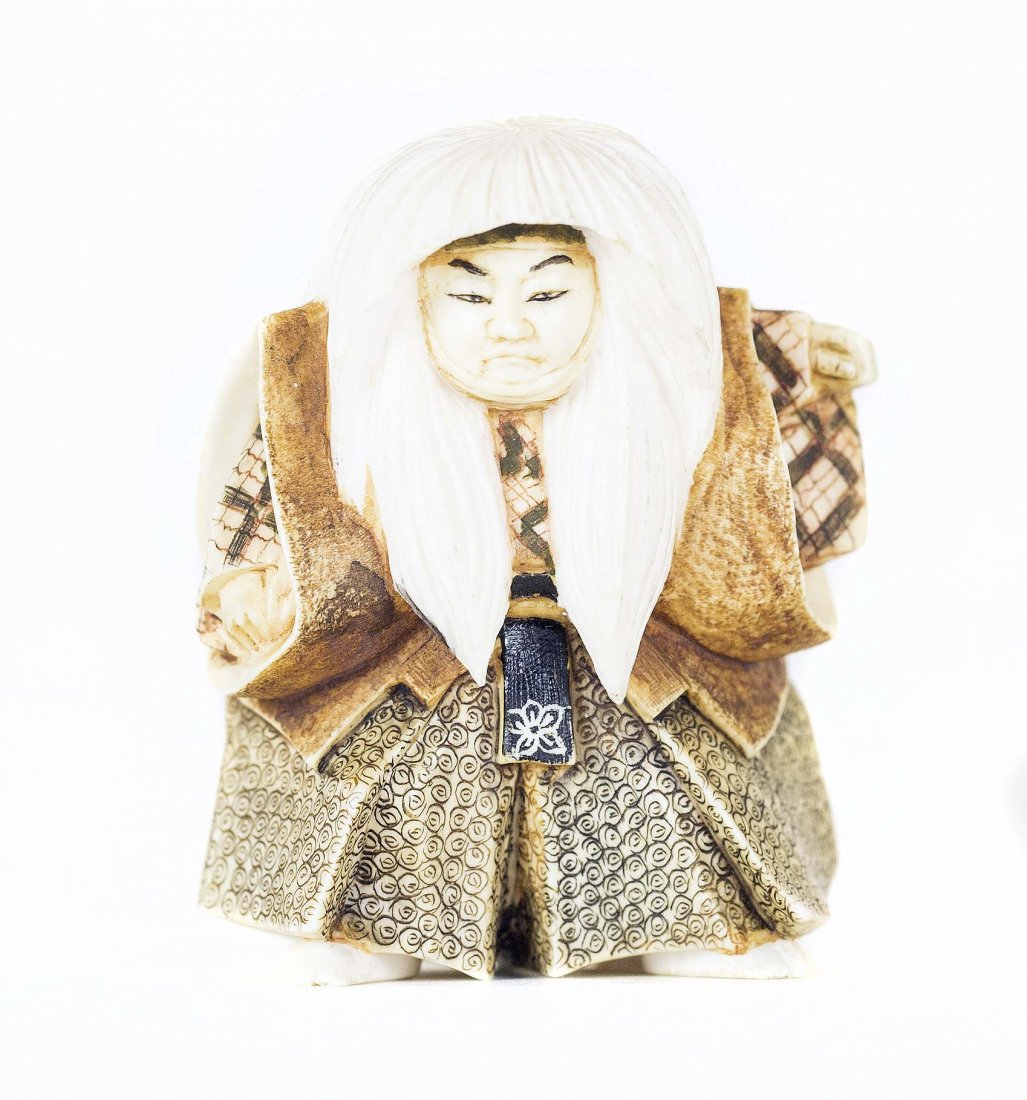 CARVED IVORY NETSUKE: PROPERTY FROM A FLORIDA COLLECTION CARVED IVORY NETSUKE Signed. Of a Kabuki dancer, in costume standing. Height 2 inches.