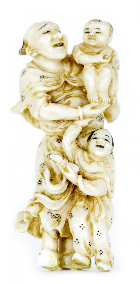 JAPANESE CARVED IVORY NETSUKE, Meiji Period (1868-1912): PROPERTY FROM A FLORIDA COLLECTION JAPANESE CARVED IVORY NETSUKE Meiji Period (1868-1912). Signed. Of a man with two boys. Height 3 1/4 inches.