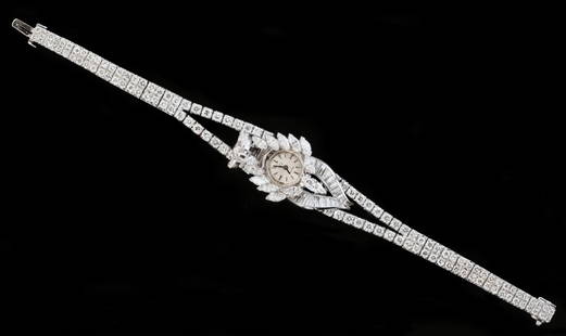 PLATINUM AND DIAMOND HIDDEN DIAL BRACELET WATCH: PLATINUM AND DIAMOND HIDDEN DIAL BRACELET WATCH Movement Swiss, signed Omega, mechanical movement. Platinum case and bracelet with concealed dial. Round, marquise, and baguette diamonds approximately