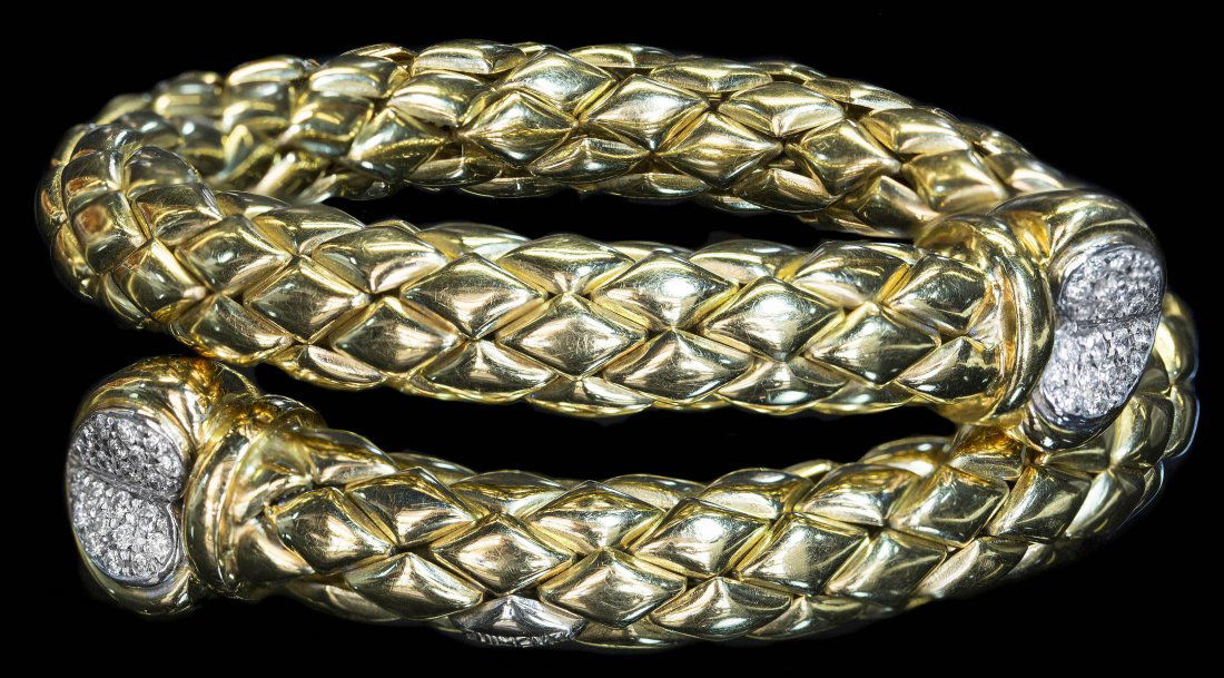 DIAMOND AND GOLD COIL BRACELET: DIAMOND AND GOLD COIL BRACELET Stamped Chimento 750. Gold coil bracelet with diamonds. Approximately .50 cts., weight 35.4 dwt.