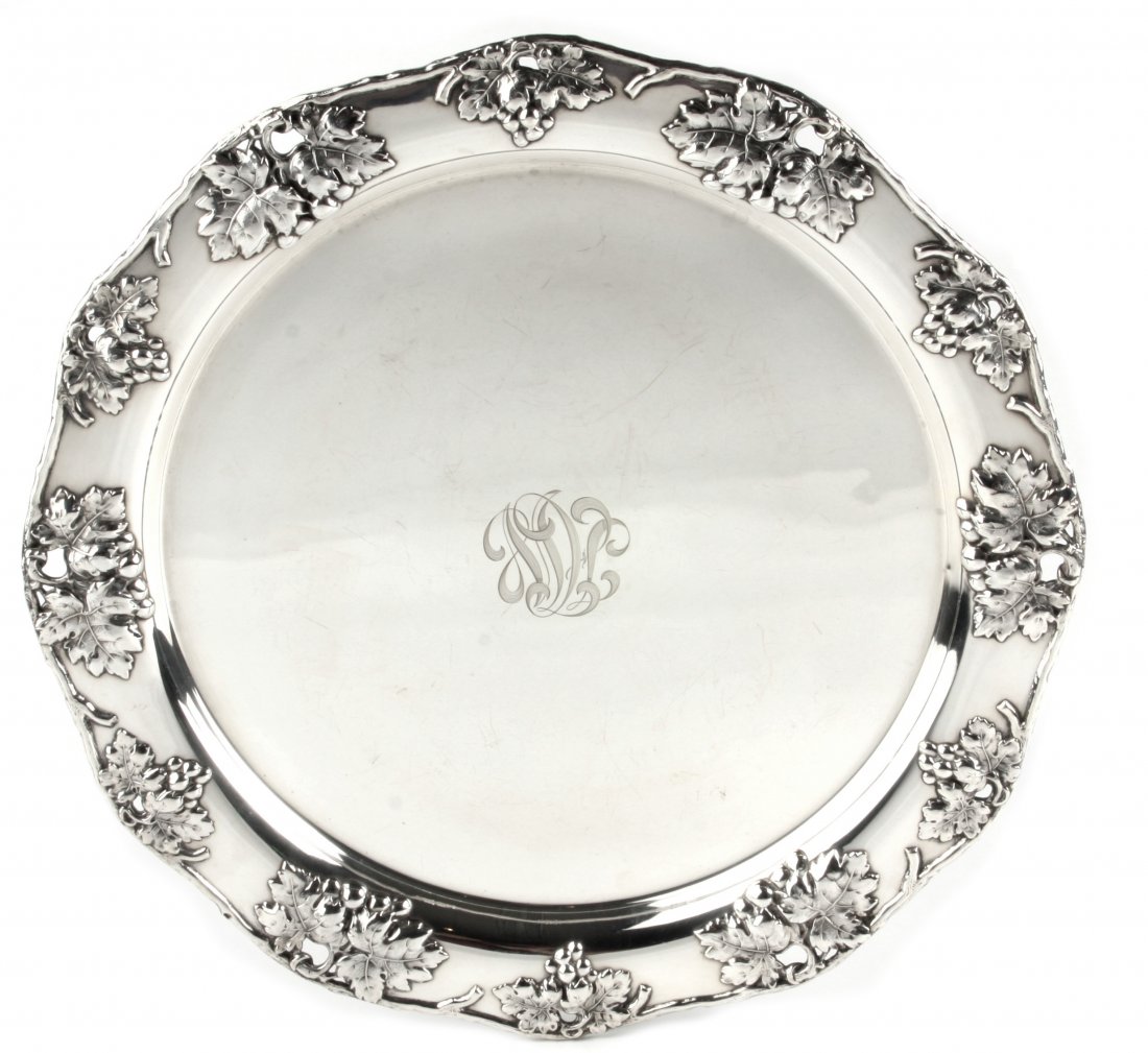 AMERICAN STERLING SILVER TRAY: PROPERTY OF A DELRAY BEACH GENTLEMAN AMERICAN STERLING SILVER TRAY Early 20th Century. Maker: Mauser MFG Co., New York. Stamped STERLING and numbered 1030A. Of circular form, the rim cast with foliage