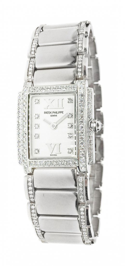 PATEK PHILIPPE TWENTY-4 GOLD AND DIAMOND BRACELET WATCH: PATEK PHILIPPE TWENTY-4 GOLD AND DIAMOND BRACELET WATCH Swiss, quarts movement. Signed Patek Philippe 750. White dial set with 10 diamonds for hour markers. Bezel and case set with 108 diamonds weighi