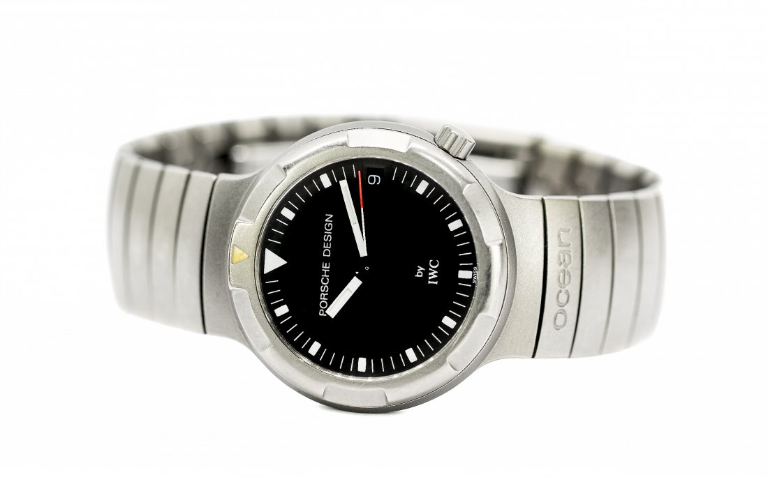 IWC TITANIUM PORSCHE DESIGN OCEAN 2000Ê: IWC TITANIUM PORSCHE DESIGN OCEAN 2000Ê Swiss. Circa 1997. The dial and case signed. The black circular dial, with batton indicators, and date at 3 o'clock, on a titanium strap with deployment buckle