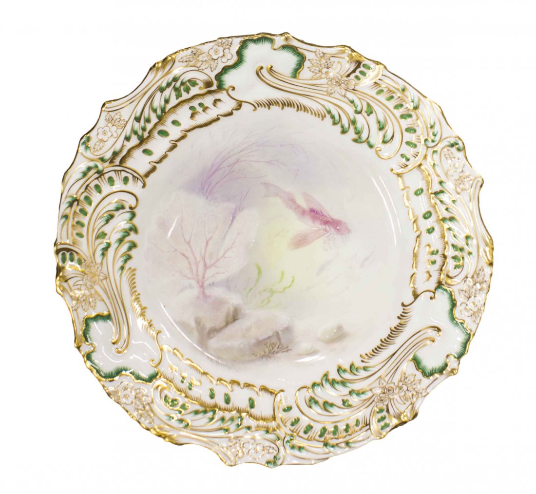 SET OF SEVENTEEN MINTON PAINTED AND PARCEL GILT GAME: SET OF SEVENTEEN MINTON PAINTED AND PARCEL GILT GAME PLATES, with a green painted and green and gold scroll-molded rim, each recessed center section decorated with different birds, the underside with