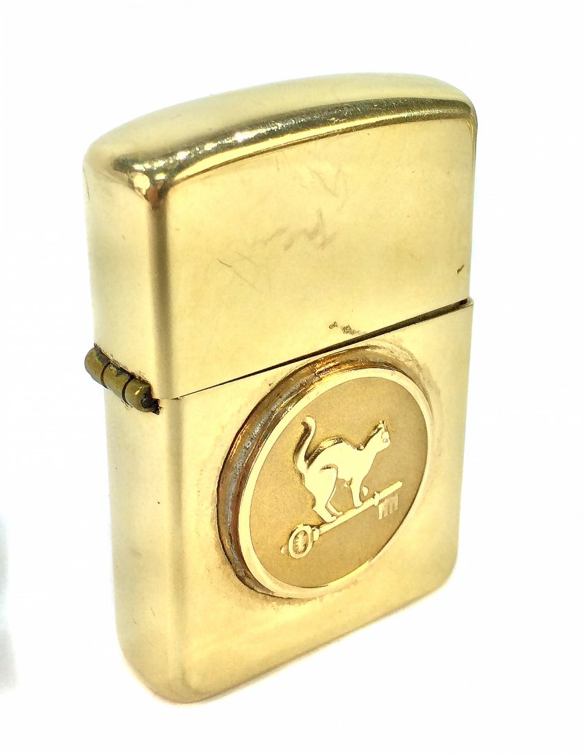 GOLD ZIPPO LIGHTER: GOLD ZIPPO LIGHTER Stamped ZIPPO, 14k. The case with monograms WBL for William Bateman Leeds and dated 9/19/55, with a medallion containing a cat walking on a key.Approximately: 1.5 inches by2.5 inche