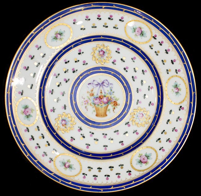 17 ROYAL CROWN DERBY SEVRES STYLE PLATES: SEVENTEEN ROYAL CROWN DERBY SEVRES STYLE PAINTED SERVICE PLATES the underside with gilt crown and pseudo interlaced •Lê in blue, with cobalt circular bands, dotted with floral sprays and centering 