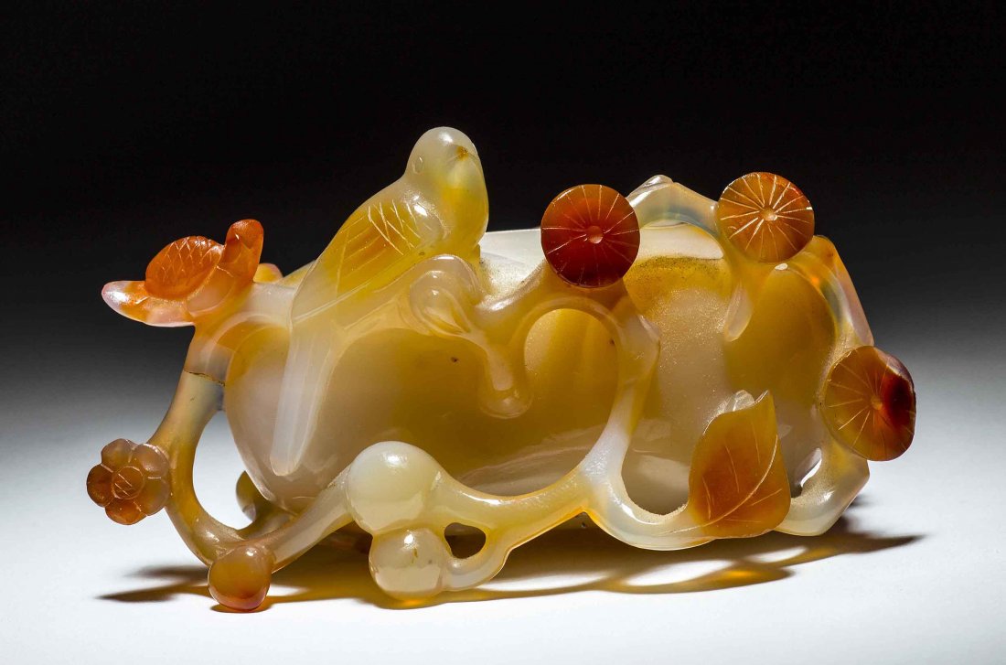 CHINESE CARVED CARNELIAN FRUITING FLORAL COUP: CHINESE CARVED CARNELIAN FRUITING FLORAL COUP Of translucent to amber with areas of deep orange. Height 3 in., Width 3 ½ in.