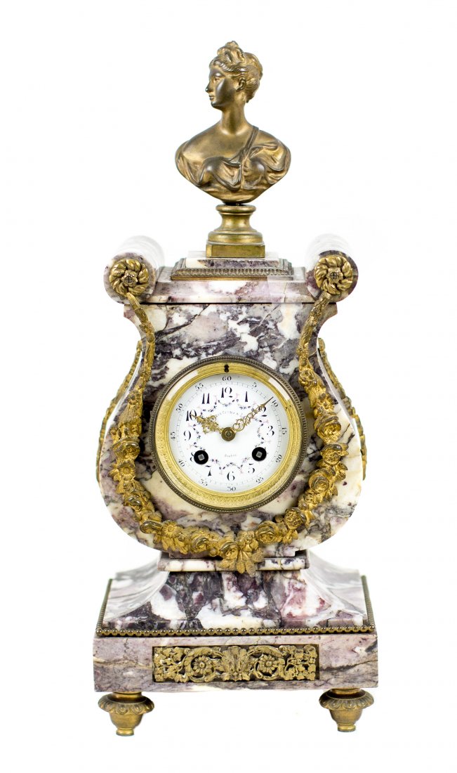 LOUIS XVI STYLE BRONZE AND MARBLE MANTLE CLOCK, C.1900: NO RESERVE - NO MINIMUM LOUIS XVI STYLE GILT BRONZE AND MARBLE MANTLE CLOCK, circa 1900, retailed by Shreve, Crump & Low, Boston, the marble case of lyre shape, surmounted by a female bust, the enamel