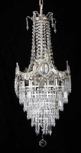 EDWARDIAN SILVERED METAL CUT GLASS CHANDELIER, C. 1900: EDWARDIAN SILVERED METAL AND CUT GLASS MULTI-LIGHT CHANDELIER, CIRCA 1900 Surmounted by a crown hung from a central metal rod surrounded by cut glass beaded chains, affixed to a circular corona. The m