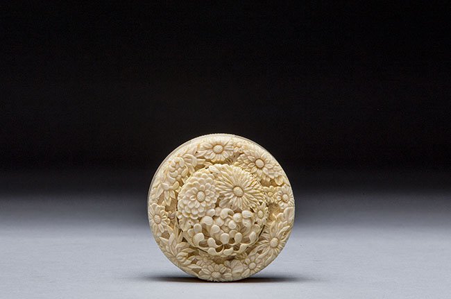 JAPANESE CARVED IVORY SMALL COVERED BOX AND COVER: JAPANESE CARVED IVORY SMALL COVERED BOX AND COVER The cover carved all over with chrysanthemums; signed. Height: 3/4 in. (1.9 cm.)